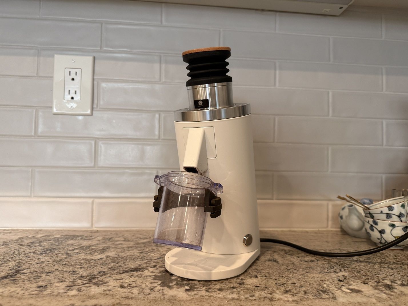 The DF54 Single Dose Coffee Grinder against a tiled kitchen backsplash.